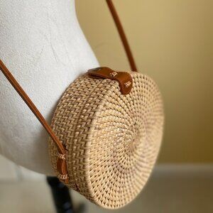Round solid straw rattan woven crossbody purse cloth lined, leather accents.